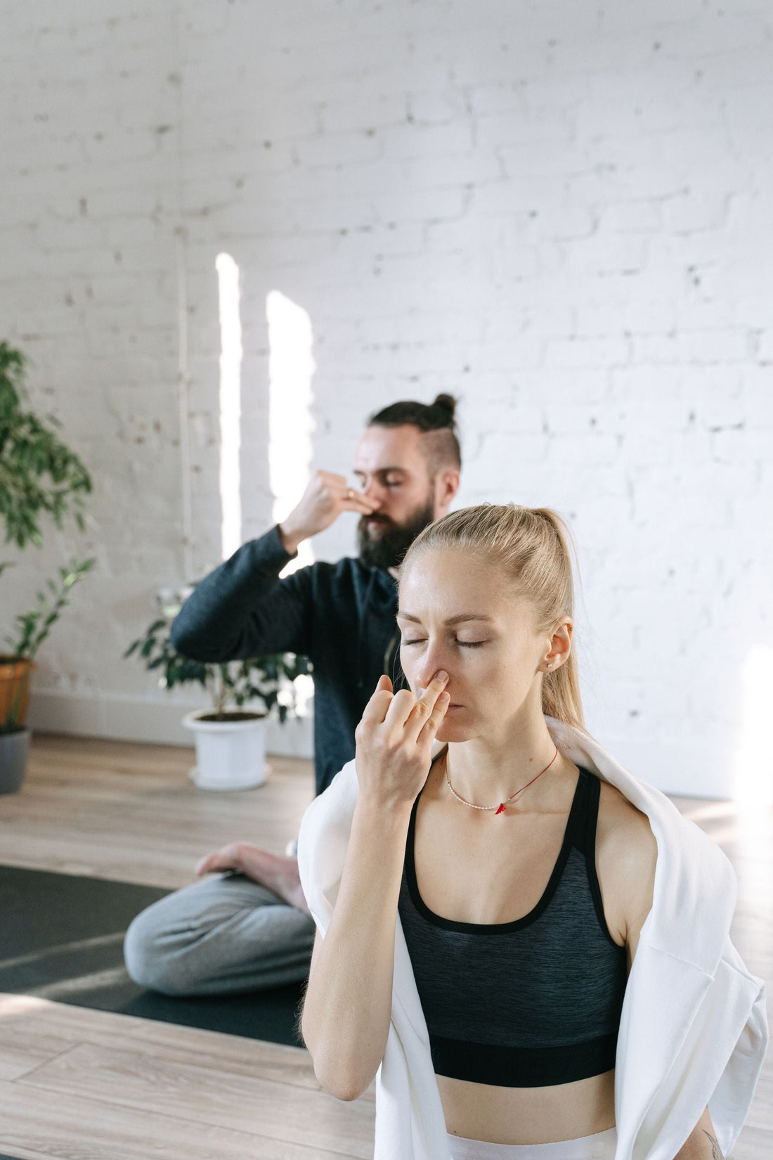 Two people practicing breathing control together