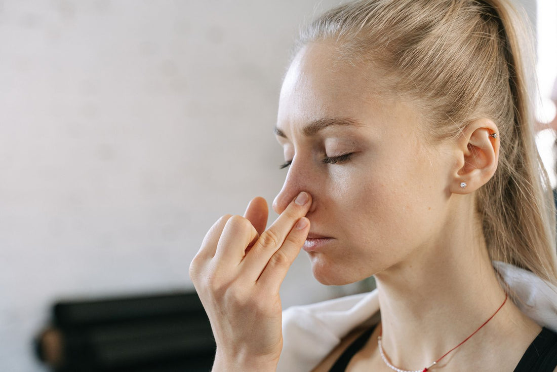 Woman practicing controlled nostril breathing