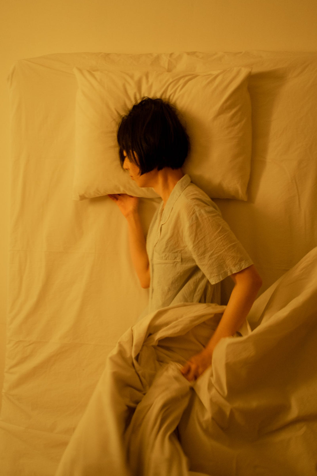 Person peacefully sleeping in a comfortable bedroom