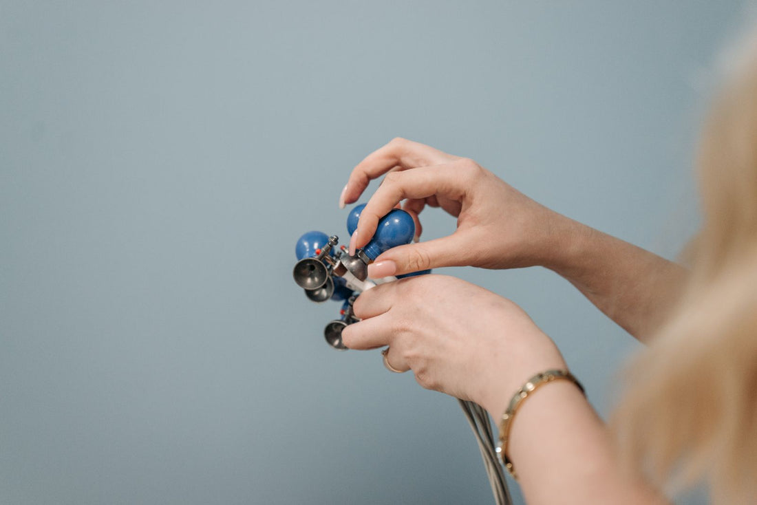Hands adjusting a healthcare device during professional care