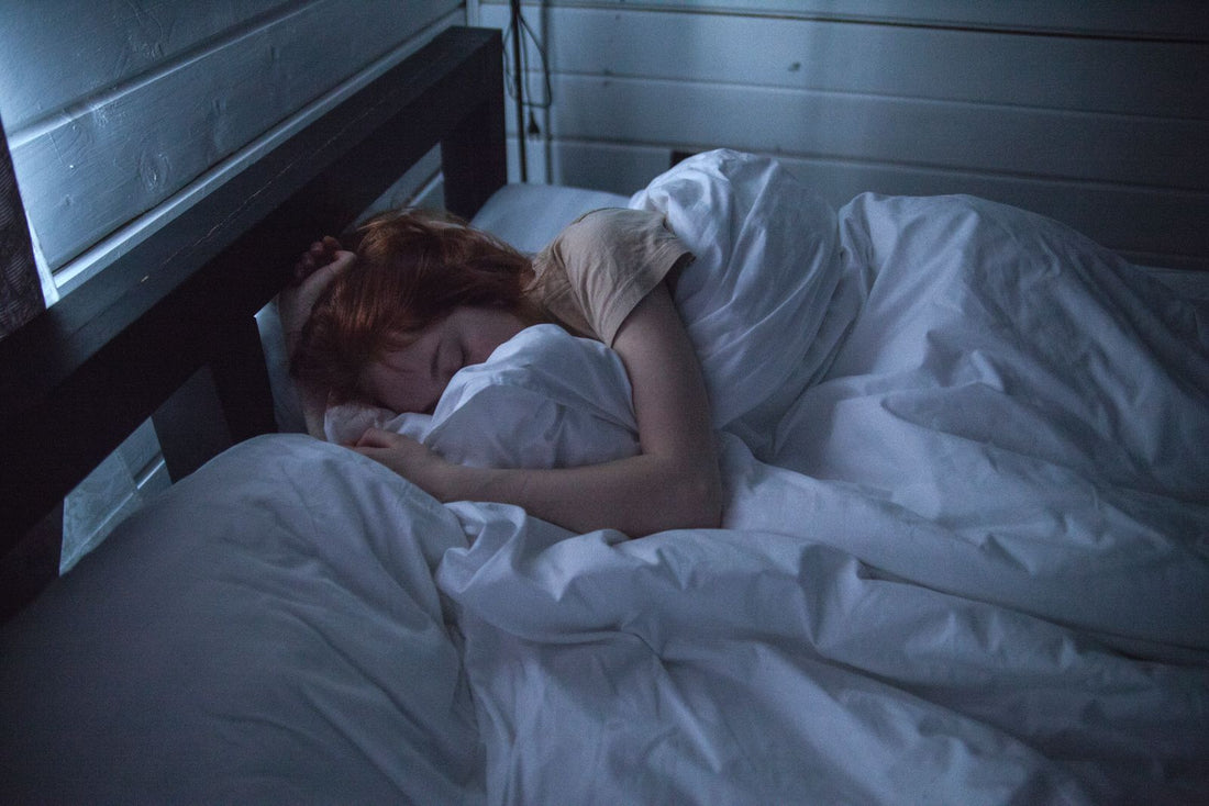 Woman sleeping peacefully in a cozy bedroom